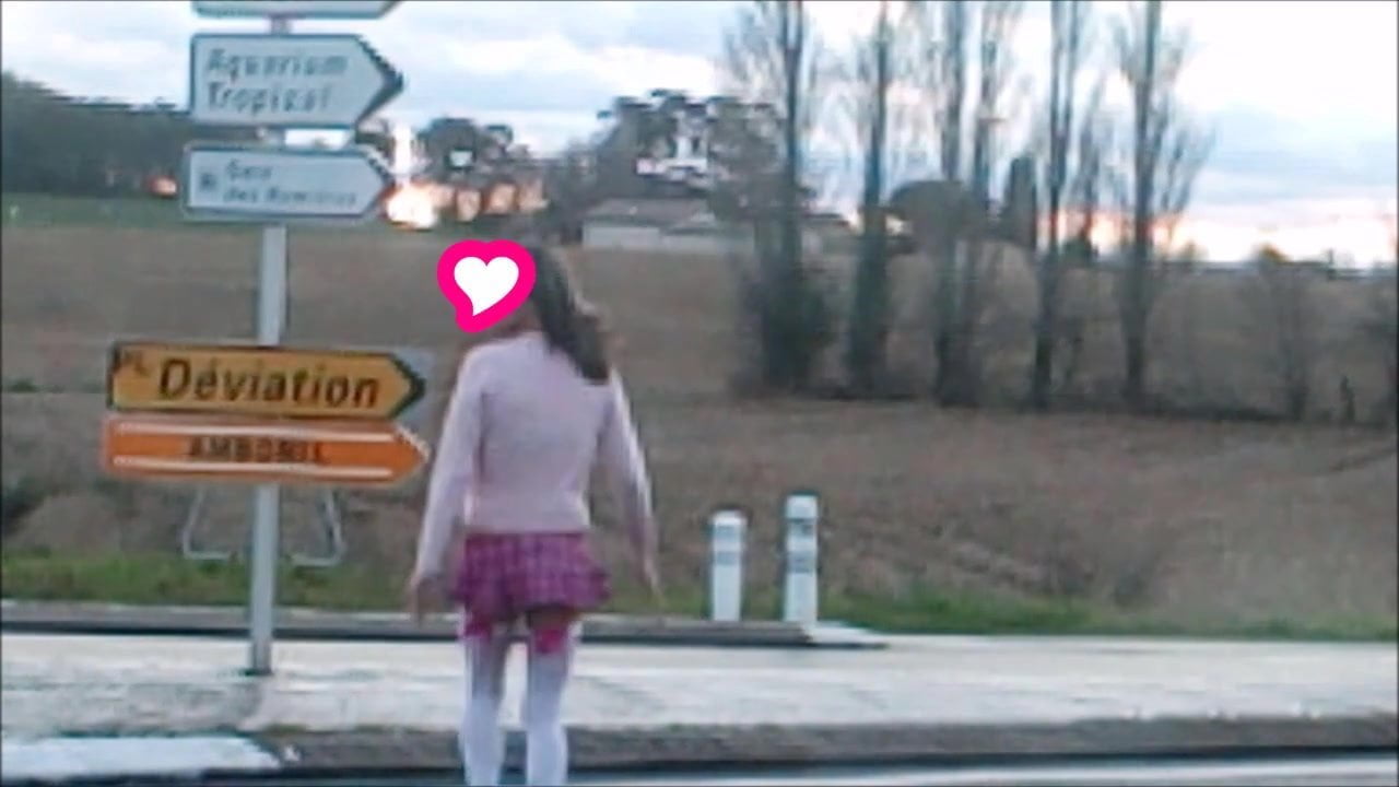 schoolgirl flashing on traffic circle roadsigns plugged
